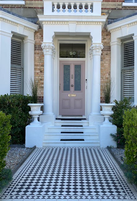 The front garden of the property features a narrow brick pathway leading to a blue front door with the number 78. The garden bed along the pathway contains well-maintained, lush green plants and a var